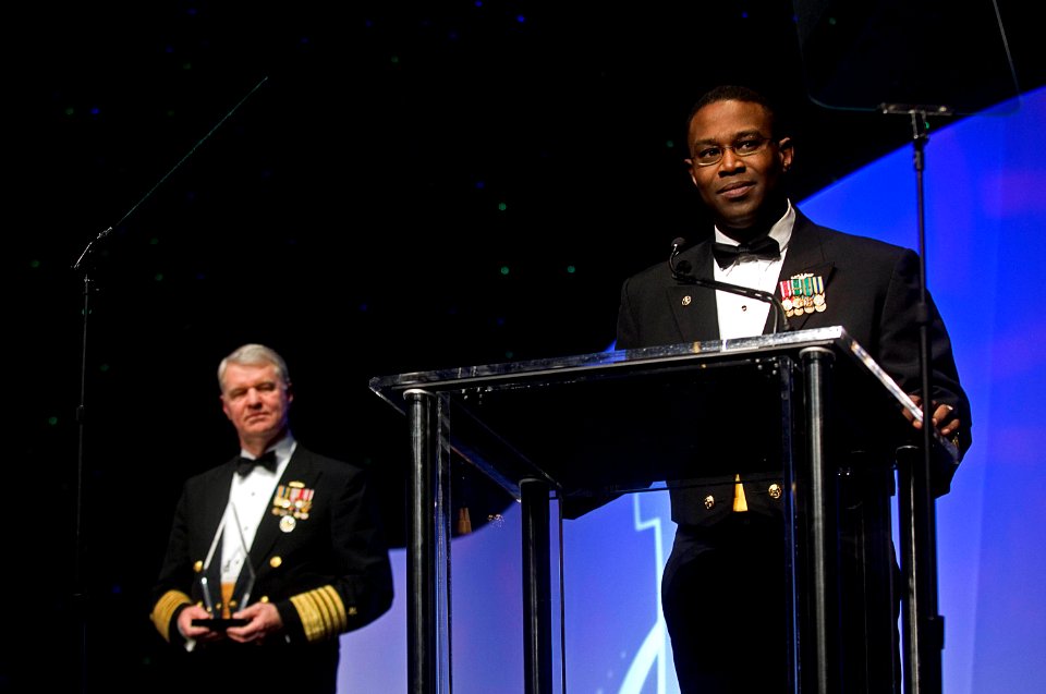 US Navy 080216-N-8273J-229 Cmdr. Richard Bryant , right gives thanks to his family after receiving the Black Engineer of the Year award for Career Achievement in Government