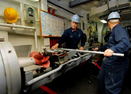 US Navy 080217-N-5476H-016 Gunner's Mate 1st Class Kacy Rupp, left, and Gunner's Mate 3rd Class Andrew Putman remove a MK46 torpedo from the MK32-MOD14 service vessel torpedo tube