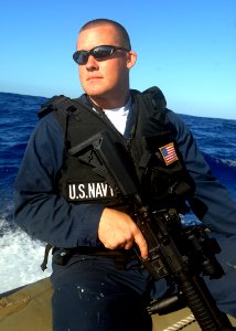 US Navy 080218-N-5476H-071 Gunner's Mate 2nd Class Jordan Govero, a native of Fenton, Mich., keeps an eye on the ocean as the gun watch aboard a rigid hull inflatable boat from the guided-missile cruiser USS Lake Erie