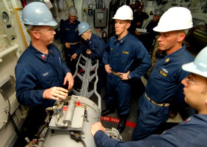 US Navy 080217-N-5476H-015 Gunner's Mate 1st Class Kacy Rupp, from Billings, Okla., explains different aspects of the plug puller mechanism of the MK32-MOD14 service vessel torpedo tube
