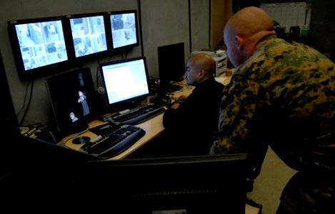 US Navy 080220-N-7676W-002 Sgt. William Jones of the Infantry Immersion Trainer (IIT) facility, and Jonell Laxa, IIT Simulator Technician, monitor a virtual scenario from the control room at the Office of Naval Research (ONR)