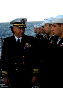 US Navy 080218-N-5476H-007 Cmdr. Richard Martel, executive officer of the guided-missile cruiser USS Lake Erie (CG 70), inspects the dress blue uniforms of Sailors during a uniform inspection on the flight deck prior to a buria