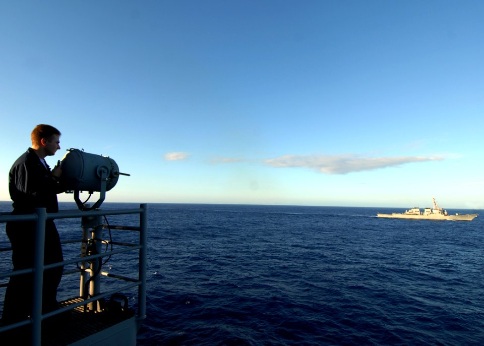 US Navy 080218-N-5476H-151 Quartermaster 3rd Class Christopher Shill signals the guided-missile destroyer USS Decatur (DDG 73) from the bridge of the guided-missile cruiser USS Lake Erie (CG 70)