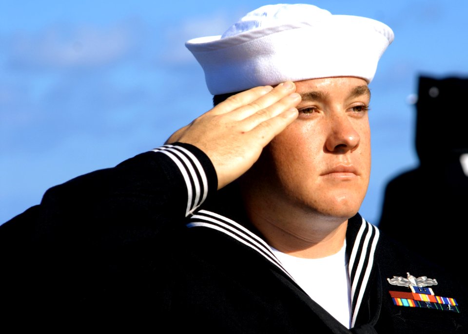US Navy 080221-N-5476H-069 Gunner's Mate 2nd Class Jordan Govero, a native of Fenton, Mo., salutes for the playing of Taps during a burial-at-sea ceremony held on the fantail of the guided-missile cruiser USS Lake Erie (CG 70)
