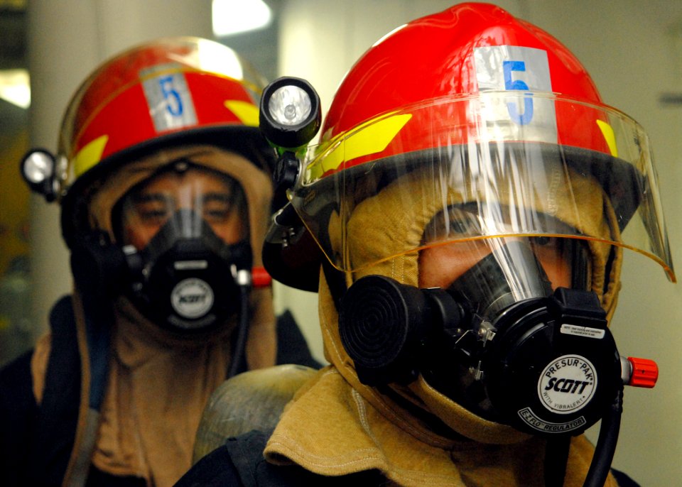 US Navy 080217-N-5476H-052 Damage Controlman 3rd Class Duane Cunningham and Damage Controlman Fireman Jose Cortez prepare to back out of a space during a damage control drill aboard the Ticonderoga-class guided-missile cruiser