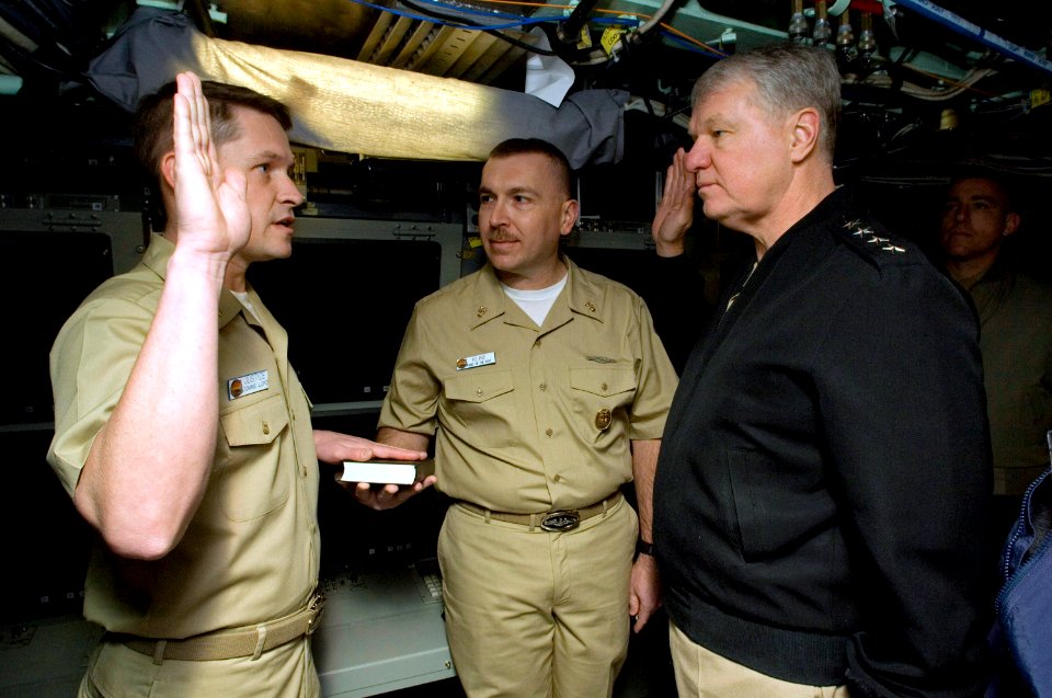 US Navy 080221-N-8273J-044 Chief of Naval Operations (CNO) Adm. Gary Roughead, right, re-enlists Chief Electronics Technician Mike Justice aboard the pre-commissioned unit (PCU) New Hampshire (SSN 778) at General Dynamics Elect