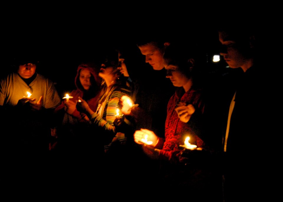 US Navy 080606-N-9860Y-006 Participants in the Relay For Life North Whidbey hold candles in honor and remembrance of cancer survivors and victims at the Oak Harbor Middle School