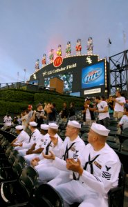 US Navy 080604-N-8848T-070 Recruit Training Command staff Sailors watch the celebration above the centerfield scoreboard at U.S. Cellular Field