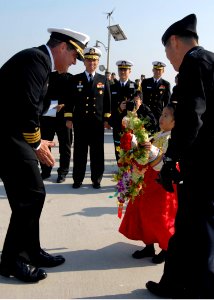 US Navy 080220-N-8534H-002 U.S. Navy Capt. Andy Hale, commanding officer of the guided-missile submarine USS Ohio (SSGN-726), receives a traditional Republic of Korea (ROK) welcome from a young Korean girl photo