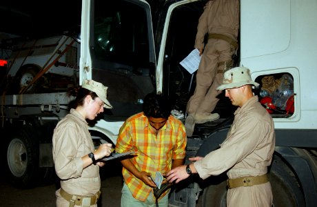 US Navy 080523-N-4198C-012 Steelworker Constructionman Chantelle Schweiger and Builder 3rd Class Joshua Knolla, Seabees assigned to Naval Mobile Construction Battalion (NMCB) 3, inspect a truck as it departs Camp Ramadi, Iraq