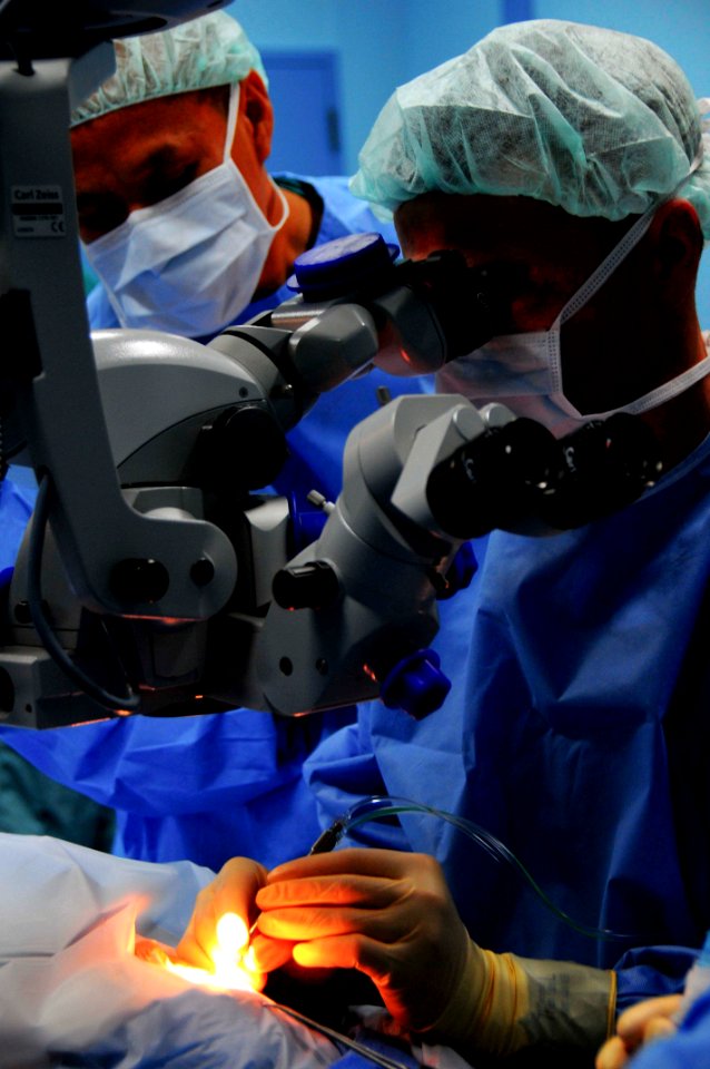 US Navy 080607-N-9689V-011 Cmdr. Kenneth Kubis, director of surgical services aboard the Military Sealift Command hospital ship USNS Mercy (T-AH 19), uses an operating microscope