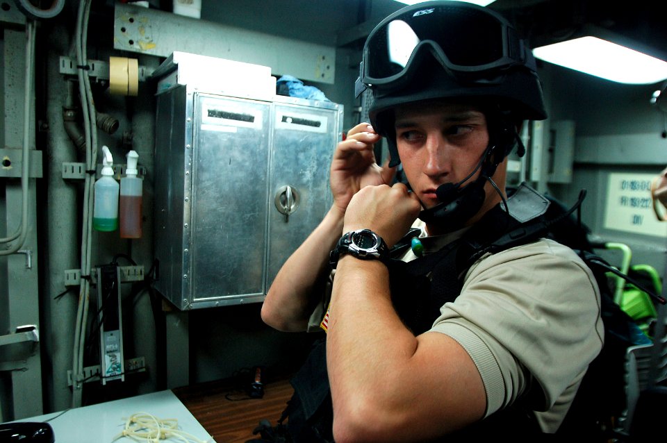 US Navy 080218-N-2420K-006 Boatswain's Mate 3rd Class Christian Anton straps on protective headgear before a visit, board, search and seizure procedure being conducted by the guided-missile frigate USS Ingraham (FFG 61)