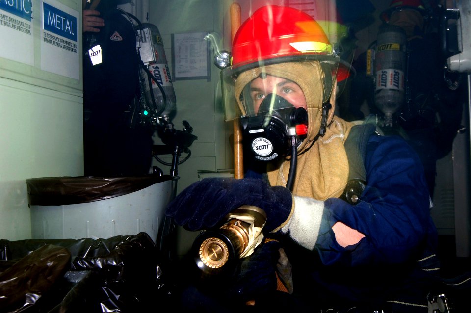 US Navy 080219-N-2420K-044 Damage Controlman 3rd Class Anthony White stands watch for a re-flash during a damage control drill aboard the guided-missile frigate USS Ingraham (FFG 61)