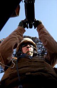 US Navy 080521-N-4198C-052 Steelworker Constructionman Chantelle Schweiger, a Seabee assigned to Naval Mobile Construction Battalion (NMCB) 3, mans a .50 cal machine gun on a mine resistant ambush protected vehicle