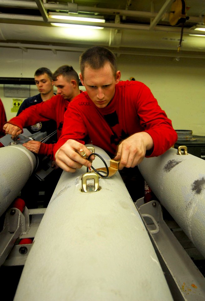 US Navy 080609-N-6538W-181 Aviation Ordnanceman Airman Stephen Goode tightens the MK-122 safety switch on a guided bomb unit (GBU) 38 aboard the Nimitz-class aircraft carrier USS John C. Stennis (CVN 74)