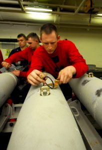US Navy 080609-N-6538W-181 Aviation Ordnanceman Airman Stephen Goode tightens the MK-122 safety switch on a guided bomb unit (GBU) 38 aboard the Nimitz-class aircraft carrier USS John C. Stennis (CVN 74)