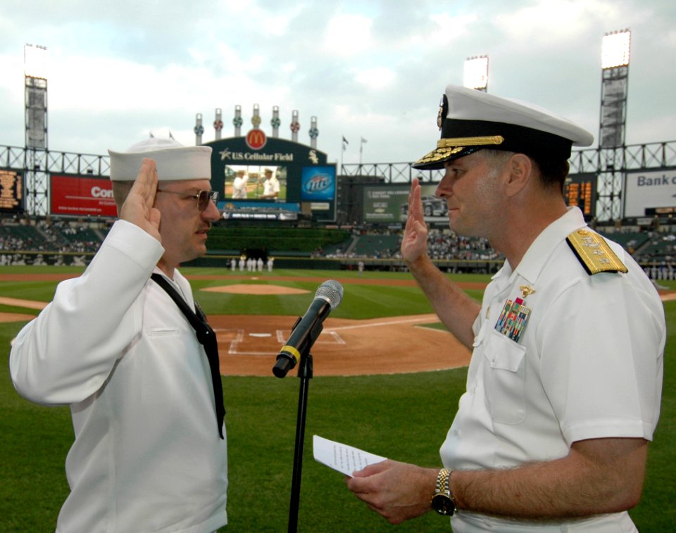 US Navy 080604-N-8848T-071 Rear Adm. Jon W. Bayless, right, the commander of Navy Region Midwest, reenlists Navy Counselor 1st Class Sean Nagle at U.S. Cellular Field