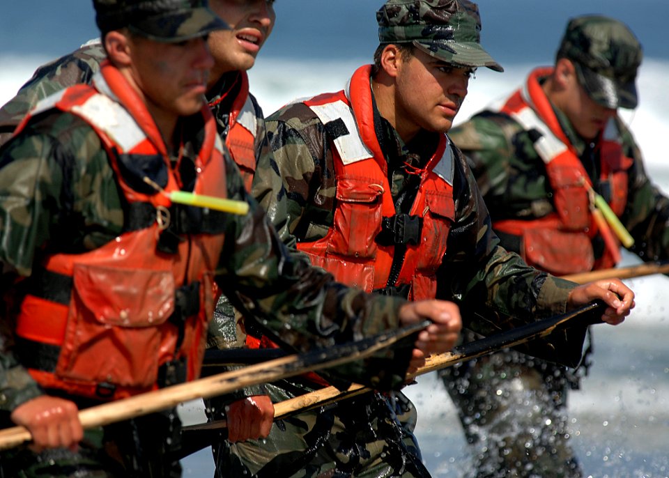 US Navy 080606-N-5366K-061 Basic Underwater Demolition-SEAL (BUD-S) students race out of the surf after completing the last exercise of Hell Week at Naval Special Warfare Center
