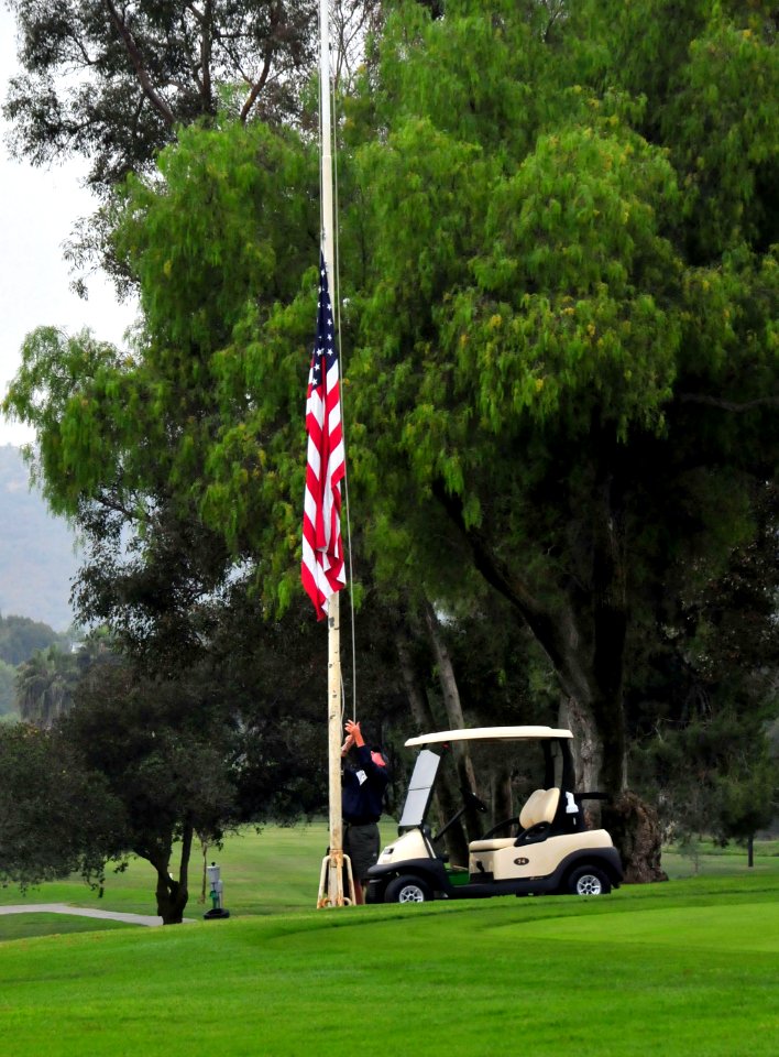 US Navy 080609-N-4774B-798 The national Ensign is raised during morning colors at the Admiral Baker Golf Course during the Inaugural Guide On Charity Golf Tournament