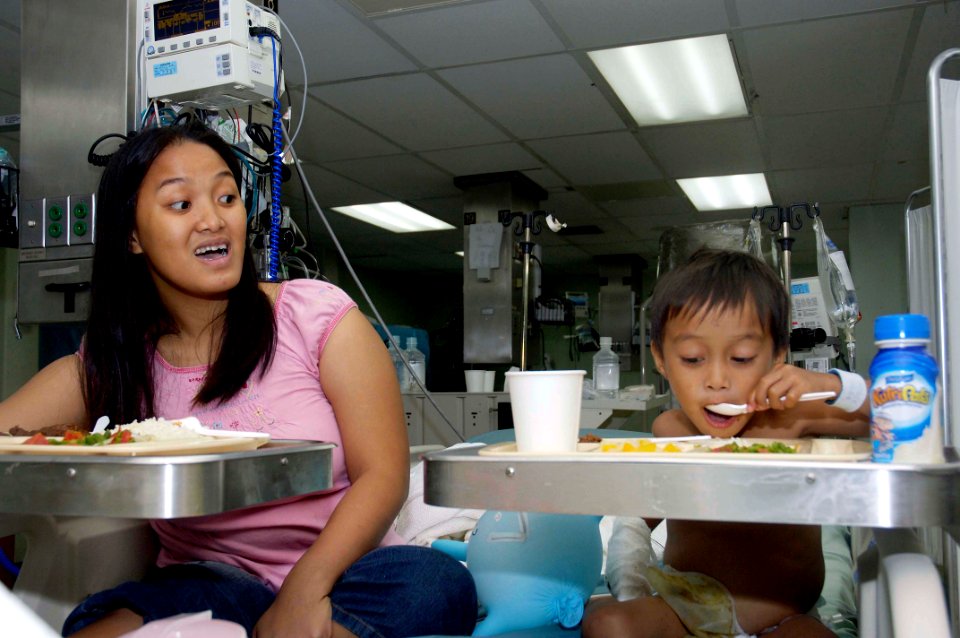 US Navy 080607-N-0209M-005 Three-year-old Jose Angelo Dacuycuy eats his first meal after having surgery to correct his Hirschsprung's disease