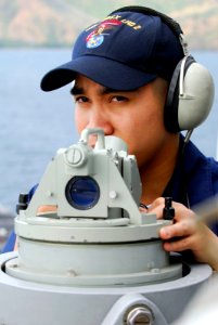 US Navy 080222-N-4010S-101 Operations Specialist 3rd Class Ruffie Salazarreports bearings to the bridge as Essex gets underway