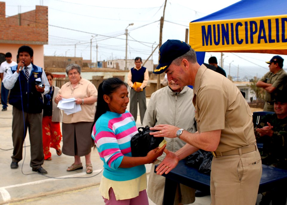 US Navy 080611-N-6410J-065 Capt. Peter Dallman, mission commander for Continuing Promise 2008, gives a Peruvian woman a Project Handclasp donation during a Project Handclasp ceremony in Huacho