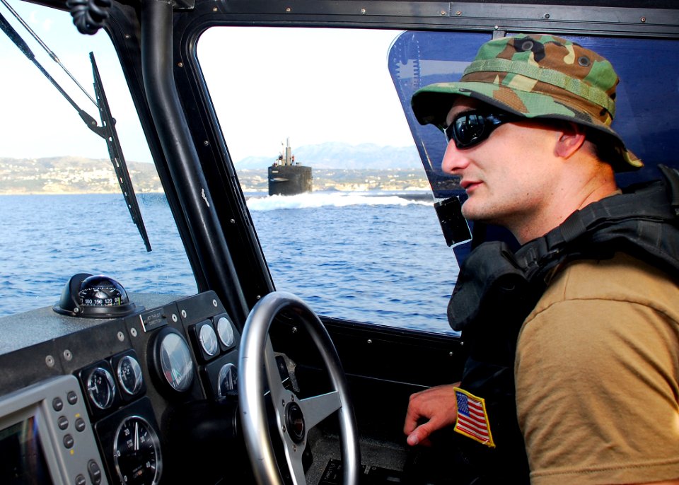 US Navy 080607-N-0780F-001 Master-at-Arms 3rd Class Jason Stroud operates a harbor security boat and scans the surrounding harbor as the fast-attack submarine USS Norfolk (SSN 714) departs the harbor