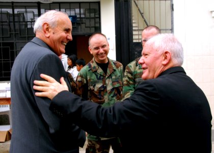 US Navy 080610-A-0348M-009 Cmdr. John Eckert, assigned to the U.S. Public Health Service and embarked aboard the amphibious assault ship USS Boxer (LHD 4), talks with Fr. Antonio Colombo and the Rev. Antonio Santasiero Rosa