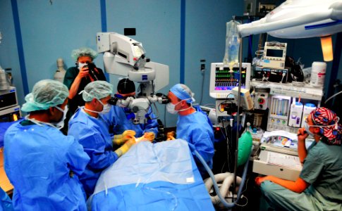 US Navy 080607-N-9689V-008 Cmdr. Kenneth Kubis and U.S. Air Force Capt. Tighe Richardson use an operating microscope while performing cataract eye surgery to return sight to Marylin Kansi, a 12-year-old girl from Cotabato