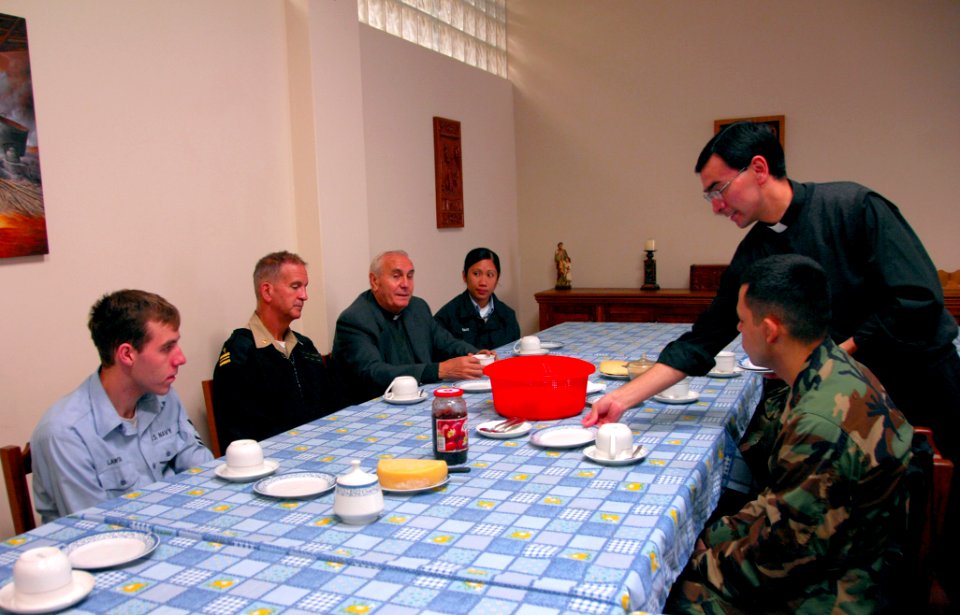 US Navy 080610-A-0348M-008 Sailors assigned to the amphibious assault ship USS Boxer (LHD 4) sit with Fr. Antonio Colombo in his church to discuss projects in the area supported by Continuing Promise 2008