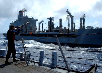 US Navy 080525-N-2838W-007 Gunner's Mate 2nd Class James Hults shoots over a line during a replenishment at sea