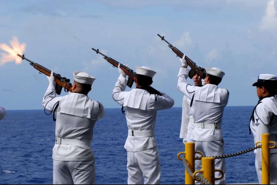 US Navy 080612-N-4995K-103 Sailors assigned to the Ship's Honor Guard renders a 21-gun salute during a burial at sea ceremony June 12, 2008.