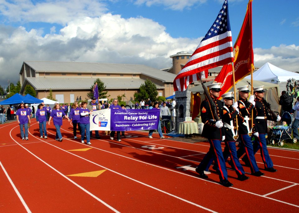US Navy 080606-N-9860Y-004 Members of the Marine Aviation Training Support Group 53 color guard lead the opening lap of cancer societies around the Oak Harbor Middle School track