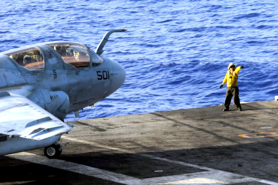 US Navy 080610-N-3659B-327 A Sailor passes control of an EA-6B Prowler assigned to the