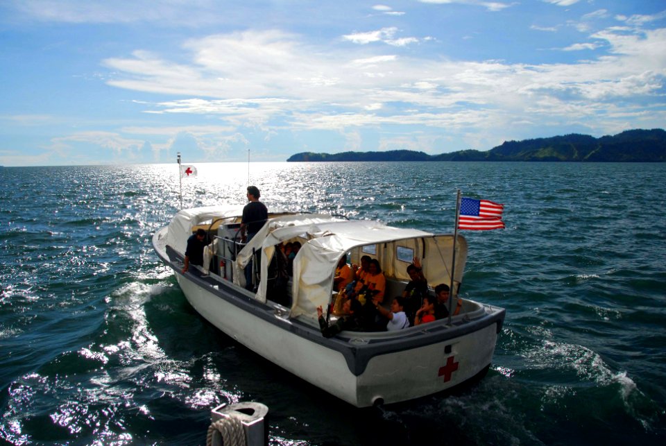 US Navy 080611-N-9689V-001 Filipino translators and volunteers wave goodbye as they depart the Military Sealift Command hospital ship USNS Mercy (T-AH 19), on the last Band Aid boat