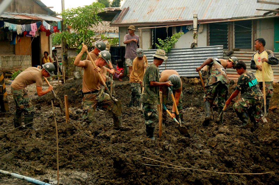 US Navy 080610-N-7498L-732 Seabees assigned to Naval Mobile Construction Battalion (NMCB) 133 and Armed Forces of the Philippines soldiers from the 546th Engineer Construction Battalion work together to dig a small trench