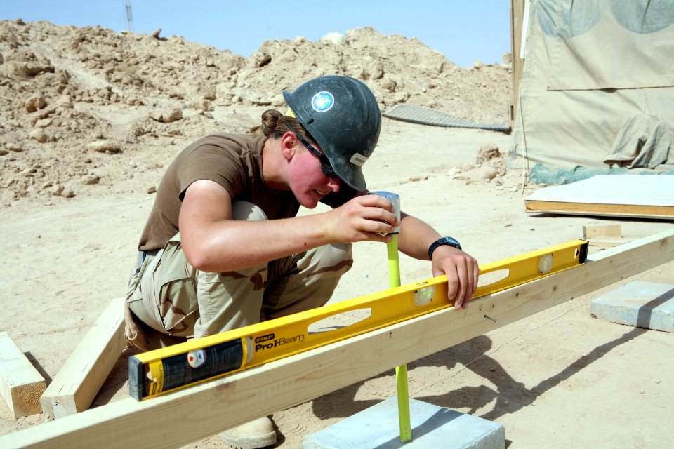 US Navy 080606-N-9623R-414 Builder 2nd Class Kathryn Henderson, assigned to Naval Mobile Construction Battalion (NMCB) 3, uses a horizontal level and tape measure