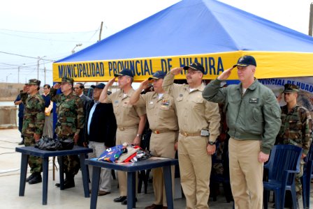 US Navy 080611-N-6410J-051 Continuing Promise 2008 mission leaders and Peruvian officials render salutes for the Peruvian national anthem during a Project Handclasp ceremony in Huacho
