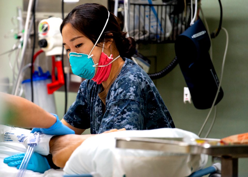 USNS Mercy Sailor Treats Patient (49834022696)