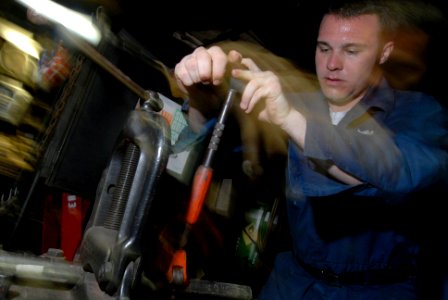 US Navy 080614-N-3946H-012 Hull Maintenance Technician Fireman Andrew Brooks, of Montclair, Calif., cuts a pipe in the pipe fitter shop aboard the aircraft carrier USS Kitty Hawk (CV 63)