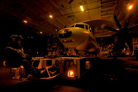 US Navy 080609-N-6538W-048 viation Boatswain's Mate (Handling) 3rd Class Seth Angelopulos uses a spotting dolly to tow an E-2C Hawkeye