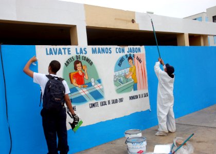 US Navy 080611-A-1539W-268 Seaman Apprentice Erik Peterson and Information Systems Technician 2nd Class Andrea Brown, assigned to the amphibious assault ship USS Boxer (LHD 4) paint exterior walls of a bathroom at Luis Fabio Xa