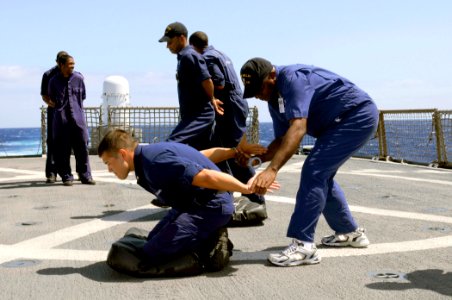 US Navy 080612-G-2443T-010 Lt. Pablo Nkisogo, a member of the Equatorial Guinea Navy, practices handcuffing tactics with Coast Guard Petty Officer 2nd Class Clifton Chang