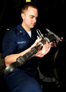 US Navy 080612-N-9898L-047 Aviation Machinist Mate 2nd Class Timothy Hayhurst inspects an actuator in the jet shop of the Nimitz-class aircraft carrier USS Abraham Lincoln (CVN 72) before installing it onto the engine an F-A-18