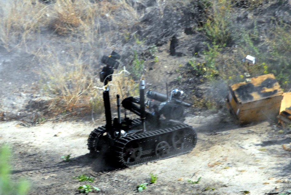 US Navy 080611-N-3289C-110 A Spanish Navy Unidad Especial Desactivad De Explosivo (U.E.D.E) MK II Talon robot disrupts a suspicious package during exercise Magre 08-1