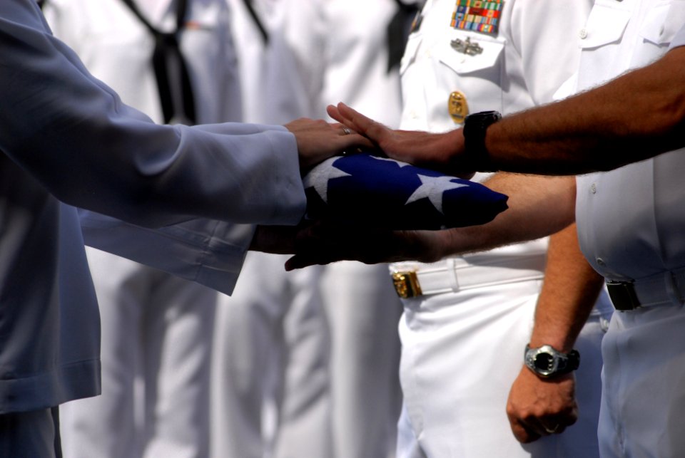 US Navy 080612-N-0640K-240 A Sailor hands Capt. Ken J. Norton, commanding officer of the Nimitz-class aircraft carrier USS Ronald Reagan (CVN 76), the ceremonial flag during a burial-at-sea ceremony
