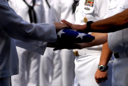 US Navy 080612-N-0640K-240 A Sailor hands Capt. Ken J. Norton, commanding officer of the Nimitz-class aircraft carrier USS Ronald Reagan (CVN 76), the ceremonial flag during a burial-at-sea ceremony photo