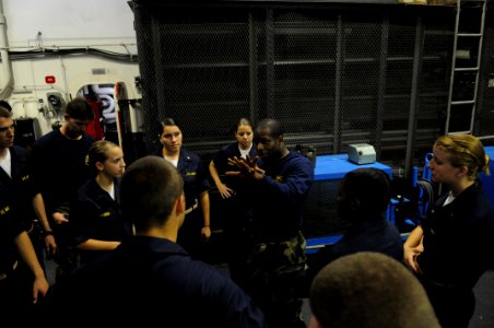 US Navy 080613-N-3659B-092 Information Systems Technician 1st Class Omari Broussard gives hand to hand combat training to a group of midshipmen in the hangar bay of the Nimitz-class aircraft carrier USS Ronald Reagan (CVN 76) photo