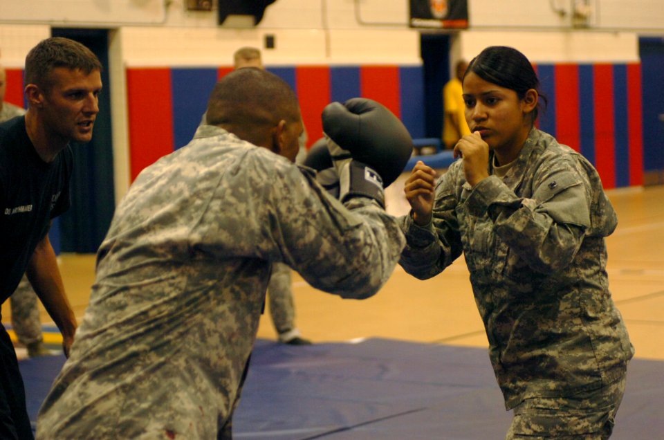 US Navy 080612-A-1912B-128 Army Spc. Evelin Andrade participates in a drill of achieving a clinch during the modern army combatives class at Denich Gym June 9-13