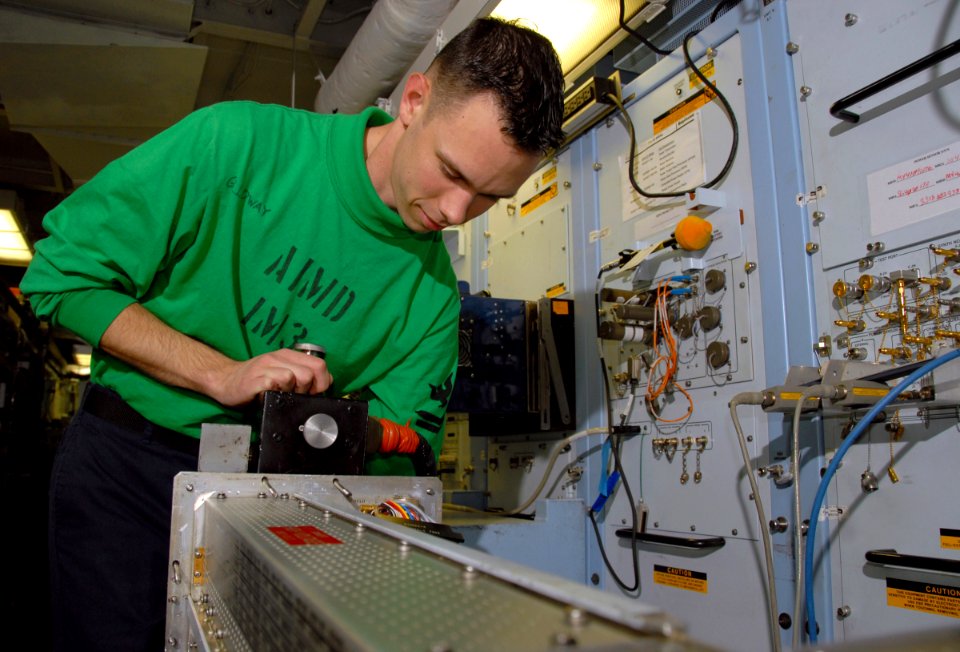 US Navy 080610-N-5617R-004 Aviation Electronic's Technician 2nd Class Victor Galloway hooks the main power cable to an ALQ-99 Air Launched Countermeasure